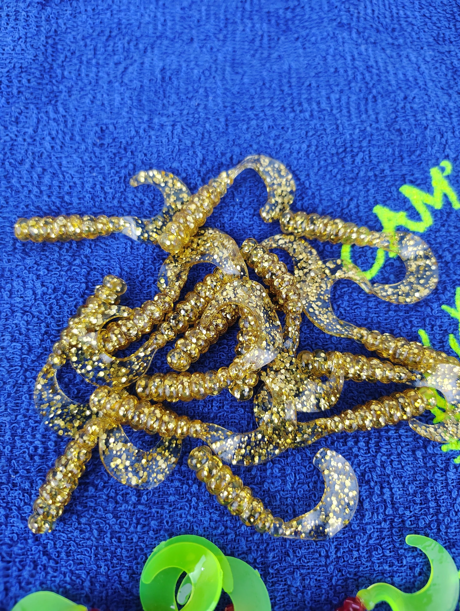 Cam's Mr October Gold and Fireball Red hand-poured curly tail crappie soft plastics
