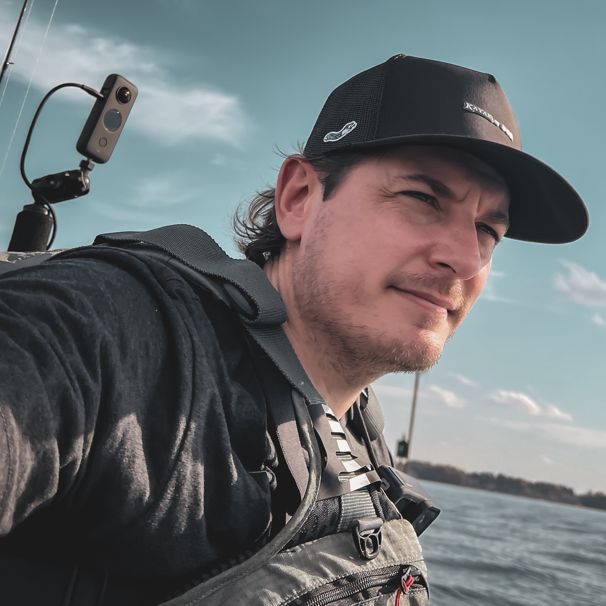 Adjustable snapback water-repellent trucker hat for kayak anglers in action
